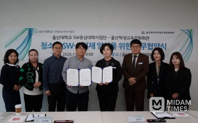 울산학생교육문화회관 김현미 관장(오른쪽)과 김대환 울산대학교 성과확산센터장이 업무협약을 체결하고 기념사진을 찍고있다