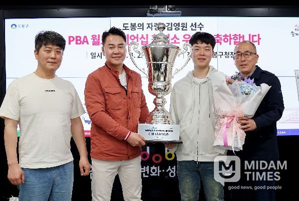 오언석 도봉구청장과 김영원 선수가 함께 트로피를 들고 기념사진을 찍고 있다